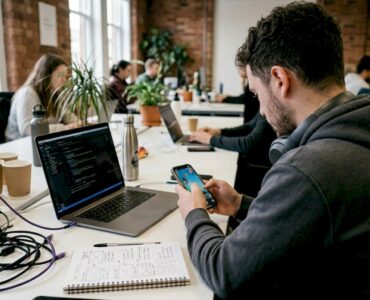 Developer testing mobile game ad at desk