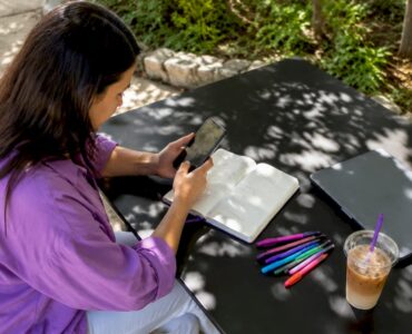 Mobile marketer reviewing ad engagement on smartphone