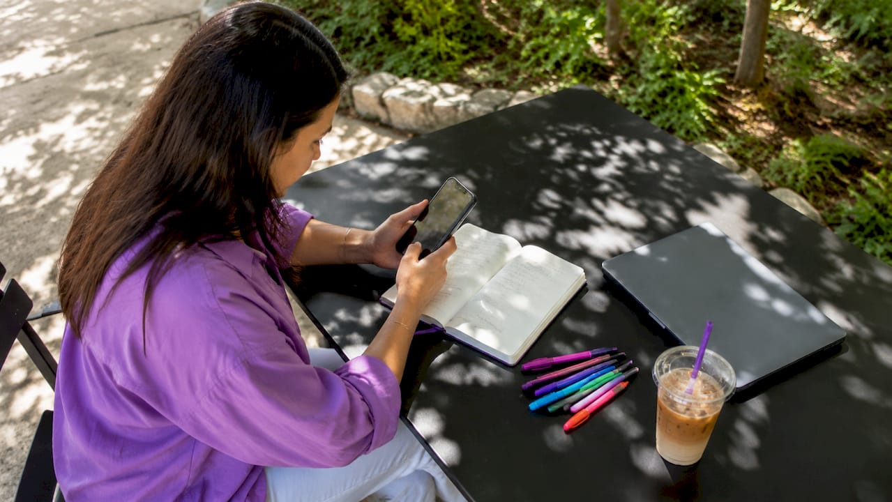 Mobile marketer reviewing ad engagement on smartphone