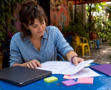 Creative manager reviewing checklist papers in office